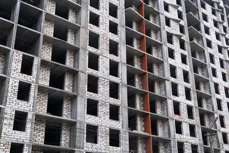 background - a wall of a multi-storey building under construction