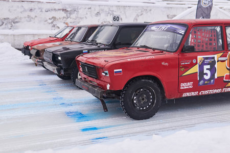 Perm, Russia - January 26, 2020: cars equipped for tough races stand at the start before an amateur...