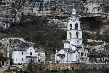 Bakhchisarai, Crimea - January 24, 2021: bell, tower, of Assumption Monastery of the Caves on the background of a cliffのeditorial素材
