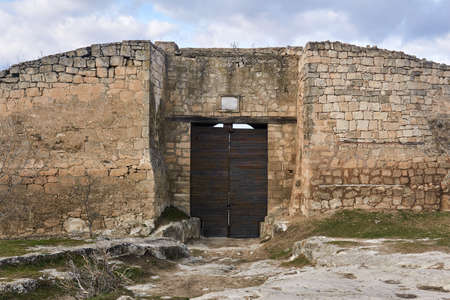 iron-lined gate to a medieval city-fortress Chufut-Kale, Crimeaのeditorial素材