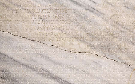 Sevastopol, Crimea - January 31, 2021: fragment of a marble slab with a carved text on the collection of taxes in ancient Greek from Chersonesosのeditorial素材