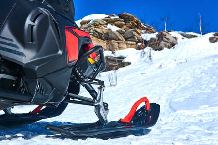 snowmobile close up on blurred mountain winter landscape backgroundの写真素材
