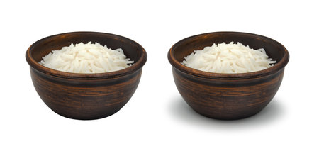 boiled white rice in simple clay bowl on white background, isolated and with shadowの写真素材