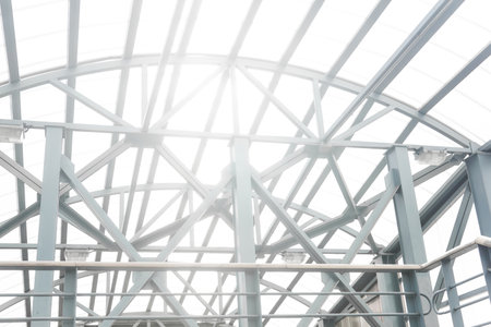 sun shines through the lattice structures of the covered pedestrian overpassの写真素材