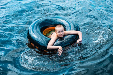 happy teen girl swimming using a swim tube