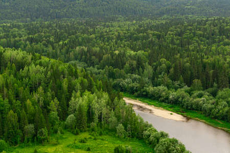 top view of a wild wooded river valley among the hillsの写真素材