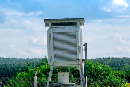 instrument shelter on a weather station with various meteorological instruments inside