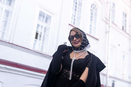 beautiful woman in headscarf in retro style outdoorの写真素材