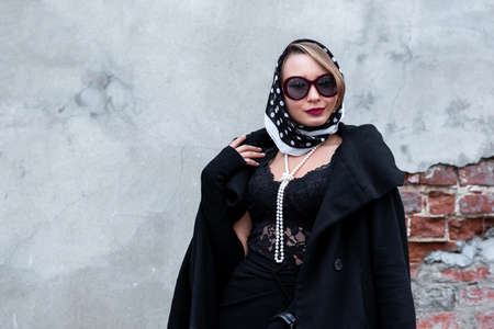 beautiful woman in headscarf in retro style outdoorの写真素材