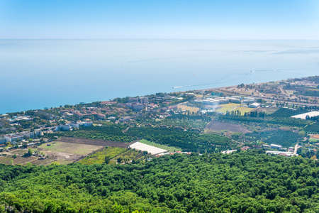 top view of Mediterranean coastal resort village with orchards and hotels in Camyuva, Turkeyの写真素材