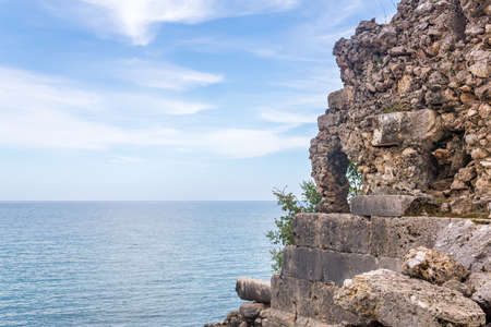 Mediterranean landscape with ruine of ancient stone building on the seashore