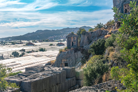 landscape of Demre town in Turkey - rock tombs of ancient Myra and modern agricultural greenhousesの写真素材