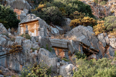 ancient stone-cut tombs on the mountain slopes above the antique city of Mira (modern Demre, Turkey)の写真素材