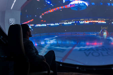 Perm, Russia - January 13, 2022: man watching educational fulldome movie