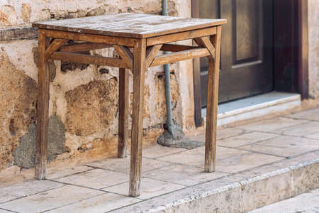 old table on the street next to the vintage buildingの写真素材