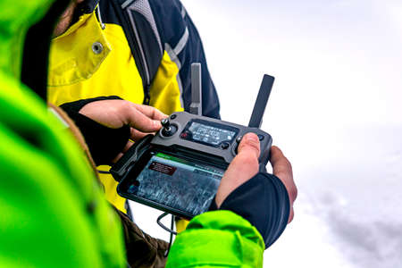 Perm Krai, Russia - February 12, 2022: remote controller of an unmanned aerial vehicle in the hands of an operator in winterのeditorial素材