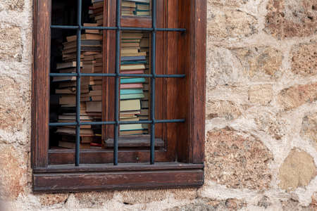 open window of a library with visible books in an ancient building