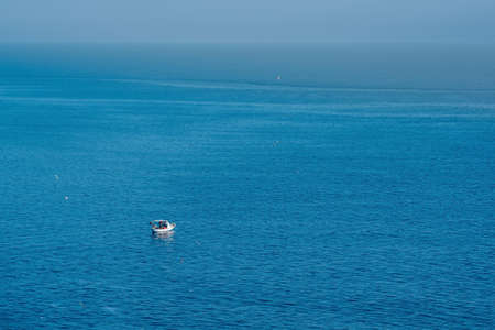 seascape with a lonely fishing boat, view from above.