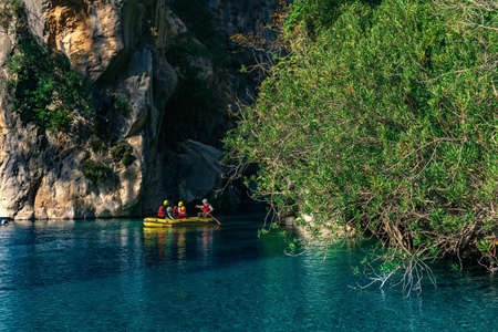 people on an inflatable boat rafting down the blue water canyon in Goynuk, Turkeyの写真素材