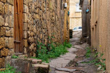 door in a narrow alley between houses in mahallas of Derbent in the historical center of the cityの写真素材