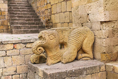 Derbent, Russia - May 09, 2022: fragments of a beast statue at the entrance to the Shah's palace in the citadel of Derbentのeditorial素材