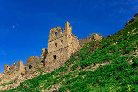 dilapidated abandoned houses on a cliff in the ghost village of Gamsutl