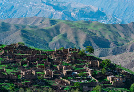 ruins of houses on a mountainside in Kurib, a depopulated village with the only remaining household with an apiary, Dagestan; another village, Chokh, is visible in the distanceの写真素材