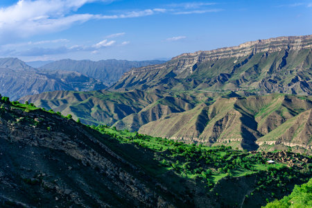 mountain landscape with a huge geological fault, a vast valley in Dagestan, the villages of Chokh and Gunib and abandoned farm Kurib are visibleの写真素材