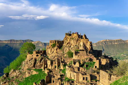 Gamsutl, Russia - May 15, 2022: view of the abandoned village on top of a mountain in Dagestan, with tourists among the ruinsのeditorial素材