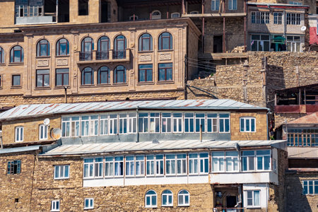 facades of houses located in tiers on a steep slope in the village of Chokh in Dagestanの写真素材