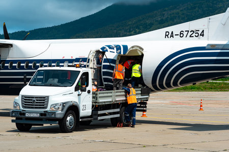 Mendeleevo, Russia - July 29, 2022: unloading luggage from the plane of the airline Aurora at the...
