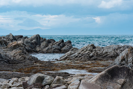 sharp jagged basalt rocks on the sea coast