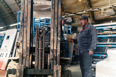 Perm, Russia - September 21, 2022: forklift driver and worker in an industrial warehouse, in the...