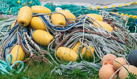 industrial fishing nets with bright floats is folded ashoreの写真素材