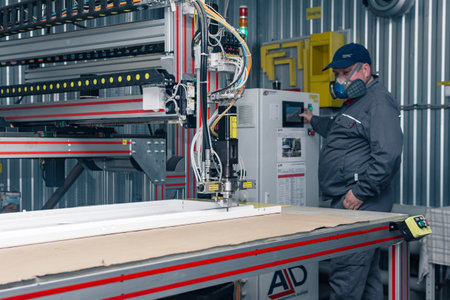 Perm, Russia - September 21, 2022: operator of industrial robotic dosing dispenser machine at workのeditorial素材