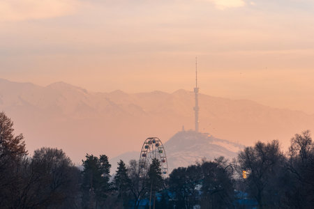 winter sunset view from city park to Koktobe mountain with TV tower in Almaty, Kazakhstanの写真素材