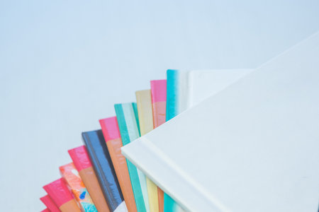 multi-colored spines of photo books close-up, partial blurの写真素材