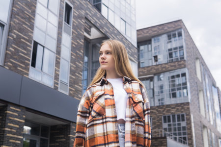 young woman on the background of city buildingsの写真素材