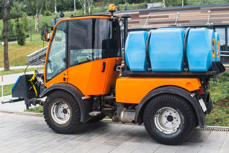 small tank truck for cleaning paths and watering plants in the city parkの写真素材