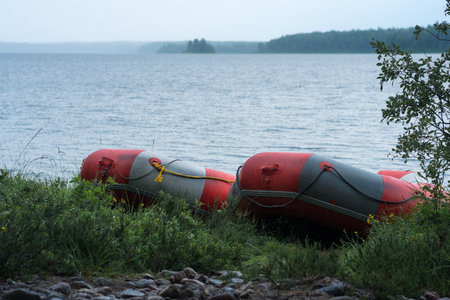 inflatable rafts is moored on the lake shore on a rainy dayの写真素材