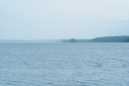 natural landscape, vast shallow lake on a rainyday, the downpour hides the distant shoreの写真素材
