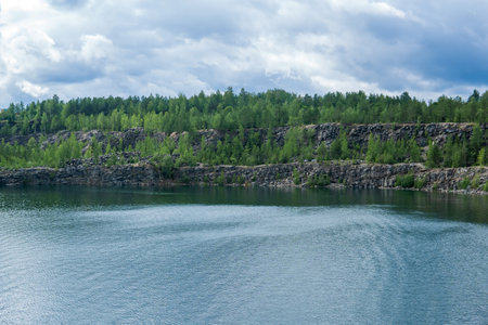 landscape with a clear lake on the site of an old stone quarryの写真素材
