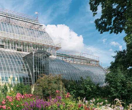 view of the Saint Petersburg Botanical Garden with flower beds and anÑient palm greenhouse in the backgroundの写真素材