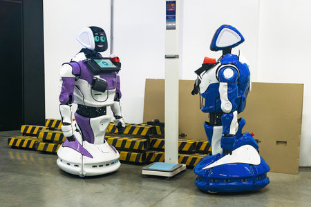 Perm, Russia - July 13, 2023: two humanoid robots with a friendly interface look at each other...