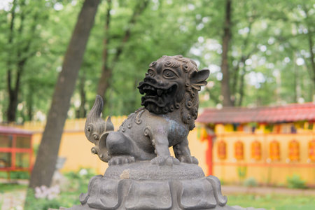 Saint Petersburg, Russia - August 01, 2023: snow lion statue on top of a large bronze incense burner in the courtyard of a Buddhist Datsan Gunzechoineiのeditorial素材