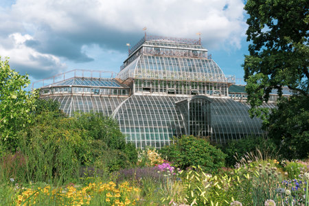 view of the Saint Petersburg Botanical Garden with flower beds and anÑient palm greenhouse in the backgroundの写真素材