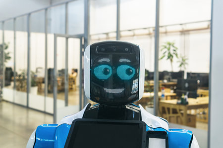 Perm, Russia - July 13, 2023: humanoid robot guide expressing emotions against the background of office interiorのeditorial素材