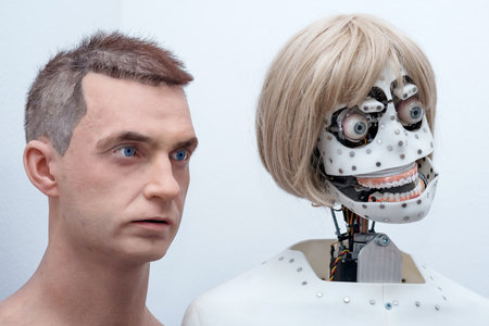 Perm, Russia - July 13, 2023: heads of anthropomorphic robots capable of imitating emotions, without face skin and with face skin, on a white backgroundのeditorial素材