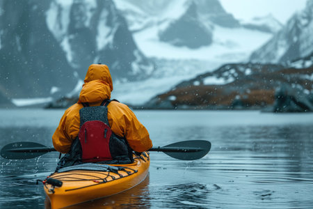 kayaker on a sea kayak against the backdrop of arctic rocky coastの素材