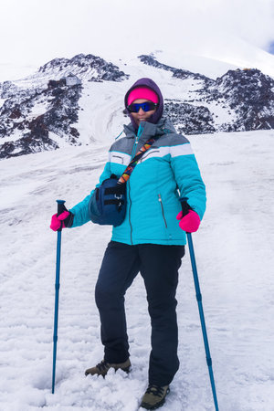 female climber on the snowy slope of Mount Elbrus on the way to the top.の写真素材